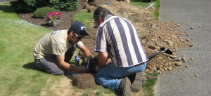 two Davie sprinkler repair technicians are install a new irrigation system